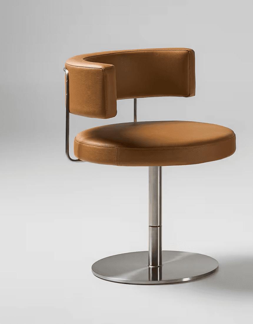 A modern swivel chair featuring a circular tan leather upholstered seat and a curved, U-shaped backrest with integrated armrests, also upholstered in tan leather. The seat and backrest are supported by a sleek, brushed metal frame that connects to a central pedestal column and a flat, circular base, providing a swivel function. — 3D model