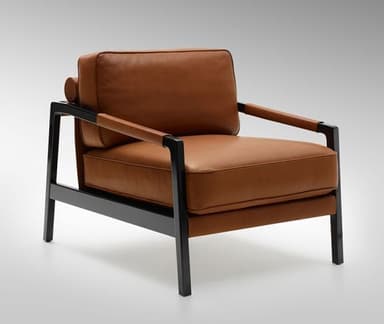 A minimalist lounge chair featuring a sturdy black metal frame and upholstered in cognac-colored leather. It has clean lines and a modern aesthetic. — 3D model