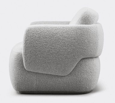 A contemporary, heavily upholstered lounge chair featuring an organic, rounded form. The chair is covered in a plush, textured boucle-like fabric in a light grey or off-white color. It has a low profile with no visible legs, appearing to sit directly on the floor or a very subtle plinth base. The backrest and armrests are integrated into the continuous, fluid shape, emphasizing comfort and softness. — 3D model