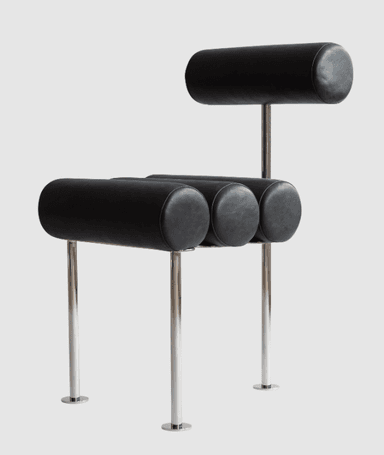 A postmodern chair featuring cylindrical bolster cushions for the seat and backrest, supported by a sleek, polished tubular metal frame. The upholstery is black, creating a striking contrast with the metallic frame. — 3D model