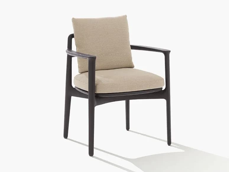 A modern armchair with a dark-colored frame and upholstered seat and back cushions in a neutral fabric. The chair features a sleek, minimalist design with slightly curved armrests and tapered legs. The cushions appear to be plush and comfortable. — 3D model