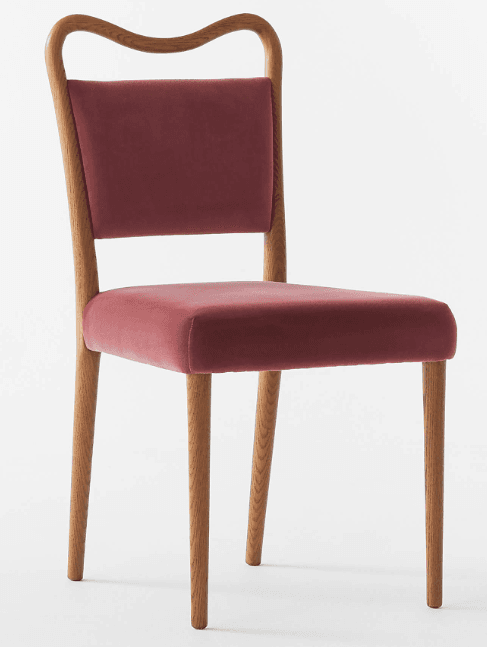 An elegant contemporary dining chair featuring a light-toned wooden frame with a distinctive curved backrest and upholstered seat and back in a reddish-pink velvet fabric. The chair has four slender, tapered wooden legs. — 3D model