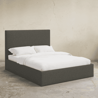 A upholstered bed frame with a rectangular headboard and a low profile base. The bed is shown with white bedding, including two pillows and a duvet. — 3D model