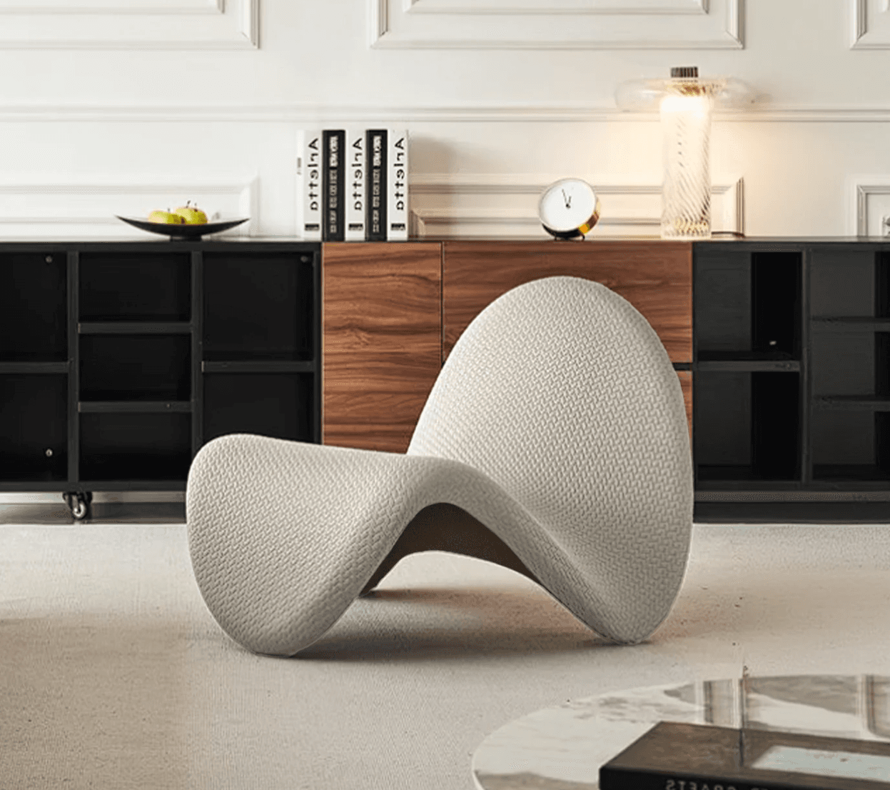 A modern, avant-garde armchair with a unique, organic, and sculptural form. It features a deeply curved, shell-like seat and backrest that appears to meld into a single continuous piece. The upholstery has a textured weave, giving it a tactile quality. The overall design is minimalist and ergonomic, intended to envelop the user. — 3D model