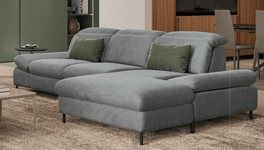 An L-shaped contemporary sectional sofa upholstered in light grey fabric, featuring adjustable headrests on multiple seating units. The sofa includes an extended chaise-like section on one end and is supported by discreet, low-profile dark metal legs. Two olive green accent pillows are placed on the sofa. — 3D model