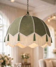 A dome-shaped pendant light fixture with a green fabric shade, featuring decorative fringe and tassels, suspended by a black chain. — 3D model