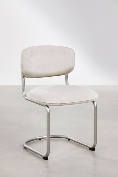 A modern armless chair featuring a bent tubular steel frame in a matte silver finish, with a padded, upholstered seat and a small, separate backrest covered in light-colored fabric. — 3D model