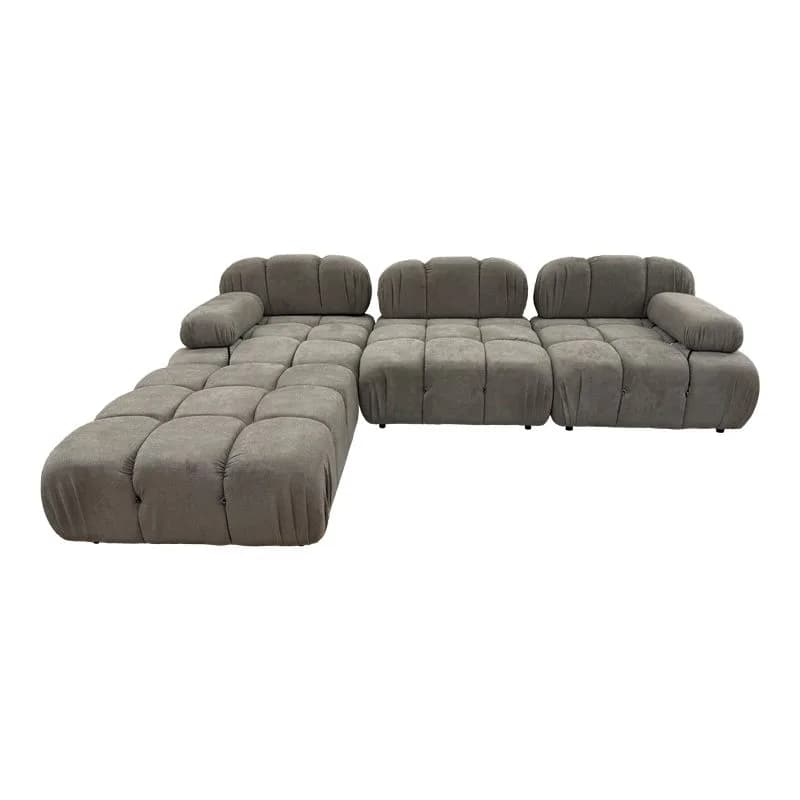 A sectional sofa with a modular design, featuring tufted cushions and rounded armrests. The sofa is upholstered in a textured fabric and has a low profile. It appears to be configured in an L-shape, with one section extending outwards as a chaise or extended seating area. — 3D model