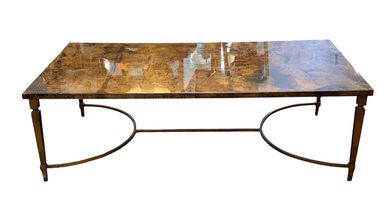 A rectangular coffee table featuring a distressed, faux marble-like top and a metal base with tapered legs and arched stretchers. — 3D model