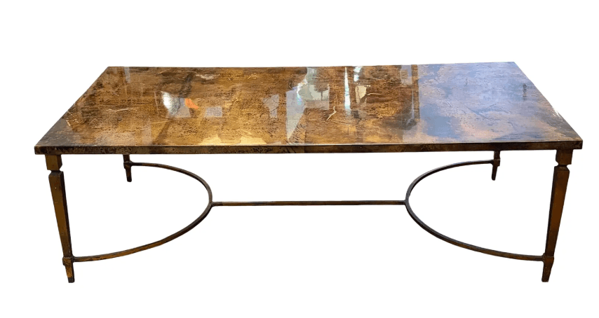 A rectangular coffee table featuring a distressed, faux marble-like top and a metal base with tapered legs and arched stretchers. — 3D model