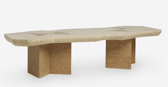 A low-profile coffee table featuring an organic-edged, light-colored travertine top with subtle geometric wood inlays, supported by two rectangular block bases made of light-toned wood. — 3D model