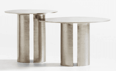 A contemporary side table featuring a round, smooth top and a solid, cylindrical pedestal base with a distinctive vertical cut-out. The table is crafted from a light gray material, likely concrete or cast metal, exhibiting a subtle texture on its base. — 3D model