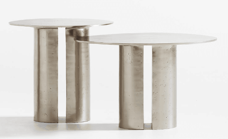 A contemporary side table featuring a round, smooth top and a solid, cylindrical pedestal base with a distinctive vertical cut-out. The table is crafted from a light gray material, likely concrete or cast metal, exhibiting a subtle texture on its base. — 3D model