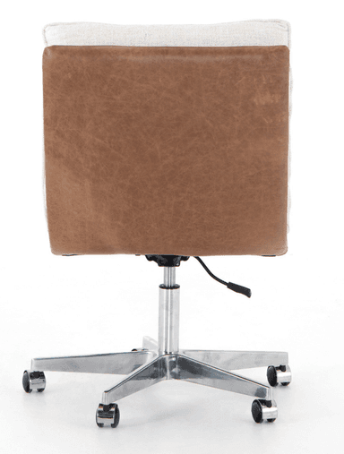An armless swivel desk chair featuring a tufted upholstered seat and backrest. The upholstery is a light, textured fabric in cream or off-white, with decorative tufting creating a grid pattern. The underside of the seat and the back of the backrest are covered in a contrasting brown material, likely faux leather. The chair sits on a polished metal five-star base equipped with casters for mobility and a gas lift mechanism for height adjustment. — 3D model