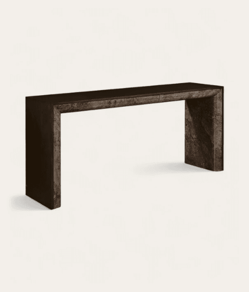 A sleek, modern console table constructed from dark, veined marble or a similar stone composite. It features a monolithic, U-shaped design with a continuous waterfall edge appearance. The tabletop presents a subtle horizontal seam, indicative of an integrated, handleless drawer. The overall aesthetic is minimalist and luxurious, showcasing the natural patterns and robust quality of the stone. — 3D model