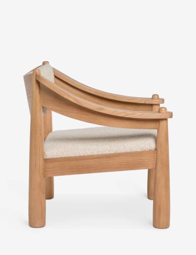 A modern armchair with a solid wood frame and upholstered seat and backrest. The frame features rounded, tapered legs and armrests, with curved supports for the back. The upholstery appears to be a textured boucle fabric. — 3D model