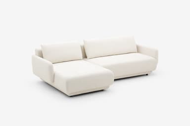 A modular sectional sofa with a chaise lounge extension. The sofa features a low-profile design with thick, upholstered cushions and rounded armrests. The frame appears to be upholstered in a textured fabric. — 3D model