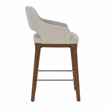 A modern bar stool with a upholstered seat and backrest, supported by wooden legs and a metal footrest. — 3D model