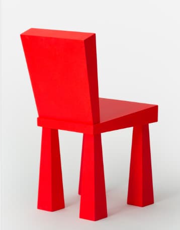 A contemporary, armless side chair featuring a striking monochromatic red finish. Its design is characterized by thick, geometric forms including a flat rectangular seat, a slightly angled backrest, and four robust, tapered legs that splay outwards from the seat. — 3D model