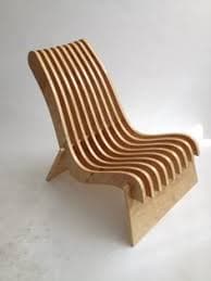 A modern chaise lounge constructed from multiple curved plywood slats, forming a wave-like ergonomic seating surface and backrest. It features a natural light wood finish and a minimalist base. — 3D model