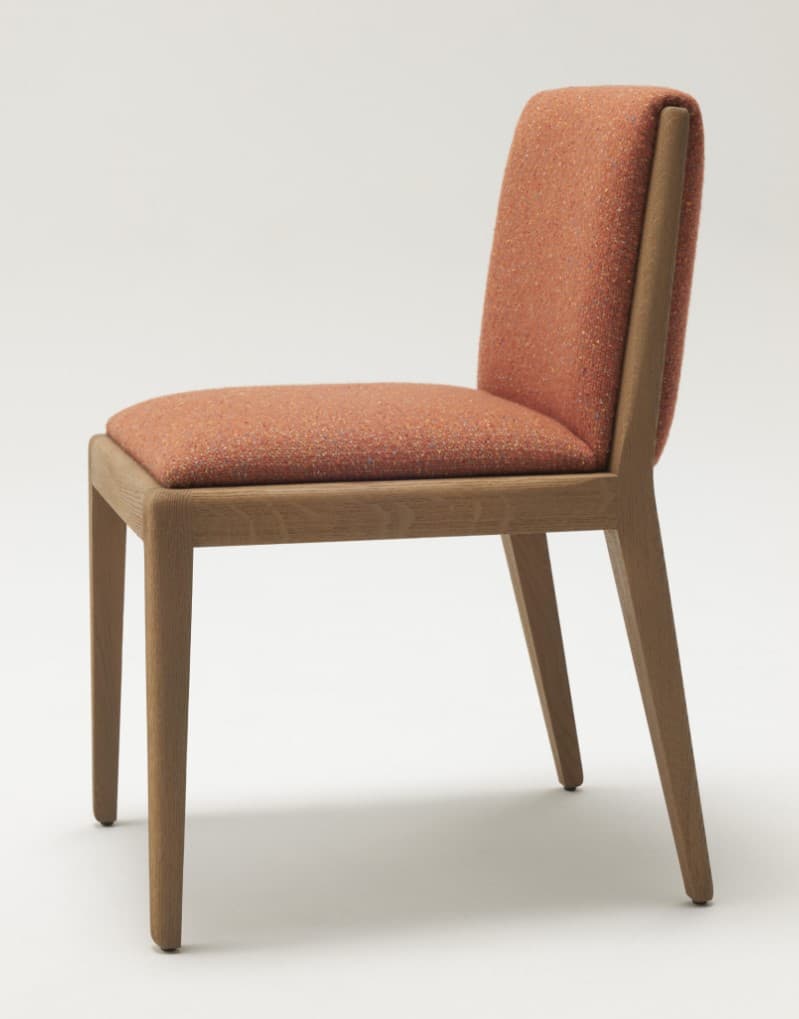 A contemporary armless chair featuring an upholstered seat and backrest in a speckled orange fabric, supported by a light-colored wooden frame with tapered legs. — 3D model