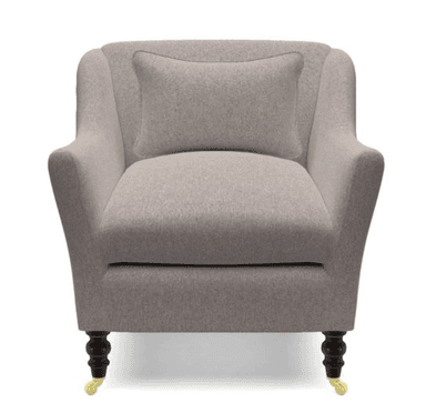 A single-seater armchair upholstered in a light grey textured fabric. The chair features a high back that curves gently into the arms, a deep seat cushion, and a lumbar pillow. It is supported by four dark wooden legs with brass casters on the front two legs. — 3D model