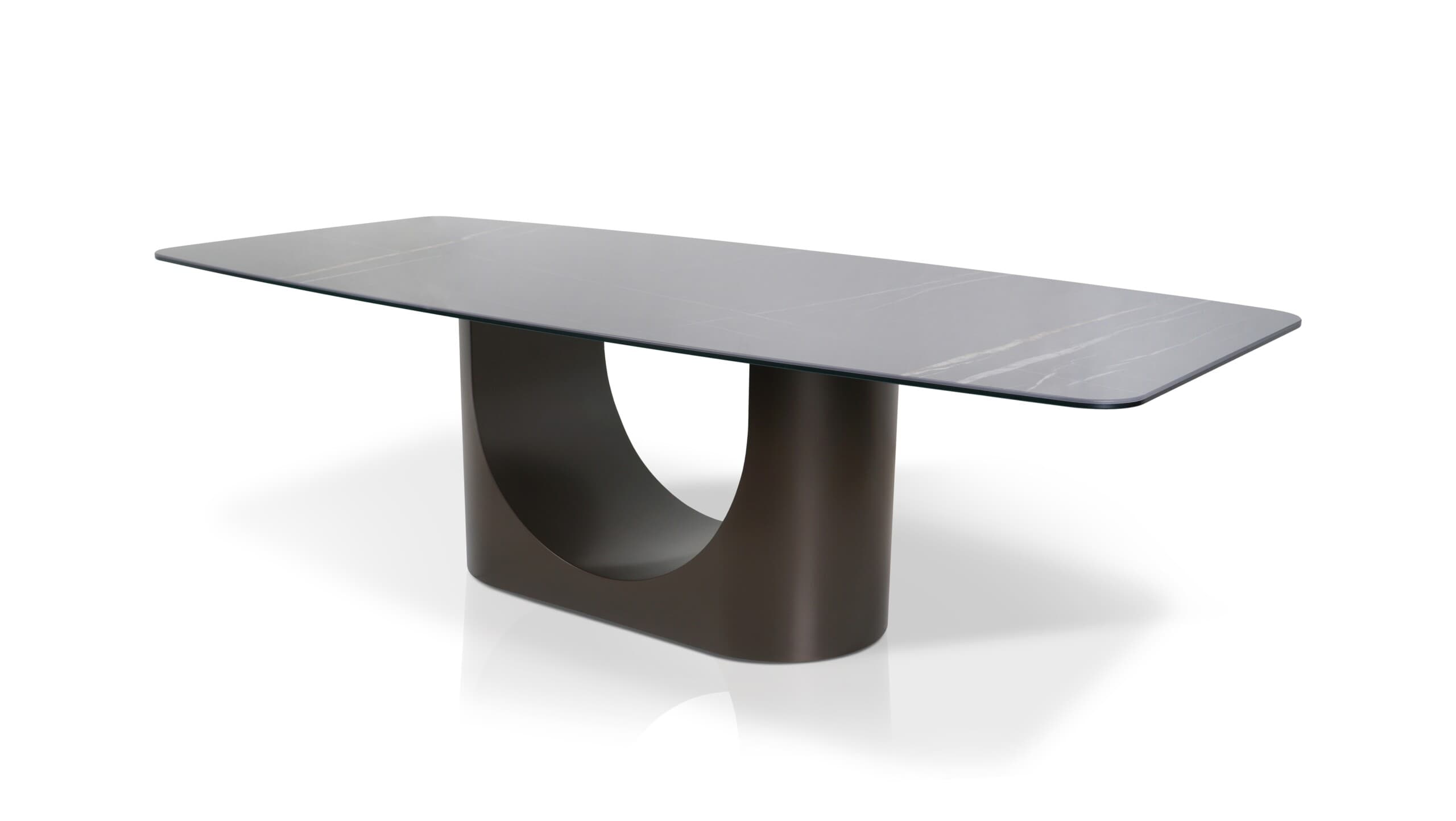 A modern dining table with a rectangular, subtly rounded tabletop and a sculptural, single pedestal base. The tabletop has a marble-like pattern with grey and white veining. The base is a dark, matte, curved structure that appears to be U-shaped when viewed from the side. — 3D model
