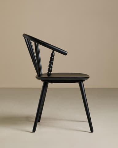 A contemporary armchair featuring an all-black finish. It has a curved spindle backrest that flows into integrated armrests. Distinctive spherical turned details adorn the ends of the armrests where they meet the seat. The seat is a flat, subtly contoured disc, supported by four splayed and tapered legs. — 3D model