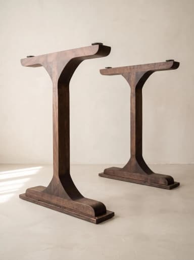 A modern T-shaped table base crafted from dark-stained wood, featuring a central column flaring into a flat rectangular top with adjustable metal connectors and a sturdy footplate. — 3D model