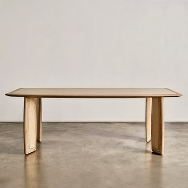 A rectangular dining table crafted from light-colored plywood, featuring a smooth tabletop with gently rounded corners and thick, curved slab-like legs that display the layered construction of the wood. — 3D model