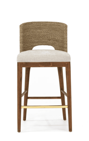 A high-backed bar stool with a solid wood frame, an upholstered seat in a light fabric, and a curved backrest made of tightly woven natural fibers. It features a brass footrest bar. — 3D model