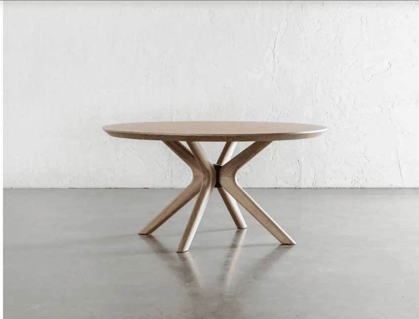 A modern round side table featuring a light-toned wooden tabletop and a sculptural base composed of multiple splayed wooden legs. The legs converge towards the center underneath the top, creating a stable and visually appealing structure. — 3D model