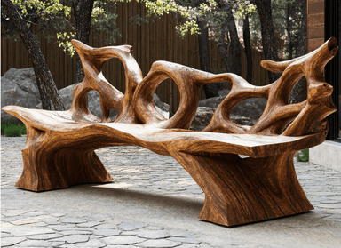 A sculptural organic wood bench, likely crafted from a single piece of rootwood or highly figured timber, featuring a seamlessly integrated seat and backrest with irregular, flowing cutouts. The natural grain and dark brown color of the wood are prominent, giving it a rustic yet refined aesthetic. — 3D model