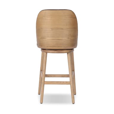 A bar stool with a wooden base and a upholstered seat and backrest. The stool has a swivel mechanism. The wooden legs are angled outwards, and there are crossbars for stability. The seat and backrest are covered in a textured fabric, likely velvet, in a brown hue. — 3D model