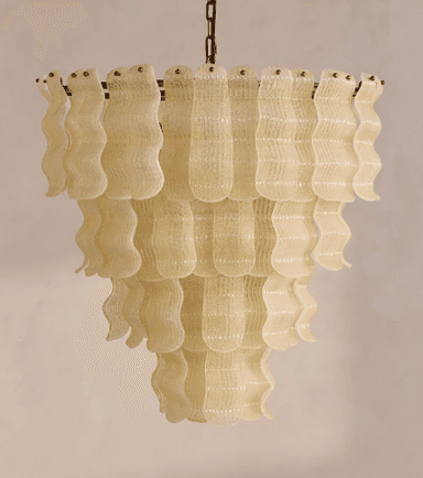 A multi-tiered chandelier with decorative elements resembling wavy glass or plastic strips. The structure is suspended by a metal chain and appears to be illuminated from within, though the light source is not directly visible. The tiered design creates a cascading effect. — 3D model