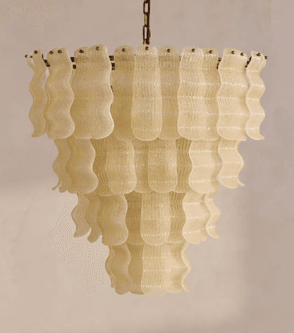 A multi-tiered chandelier with decorative elements resembling wavy glass or plastic strips. The structure is suspended by a metal chain and appears to be illuminated from within, though the light source is not directly visible. The tiered design creates a cascading effect. — 3D model