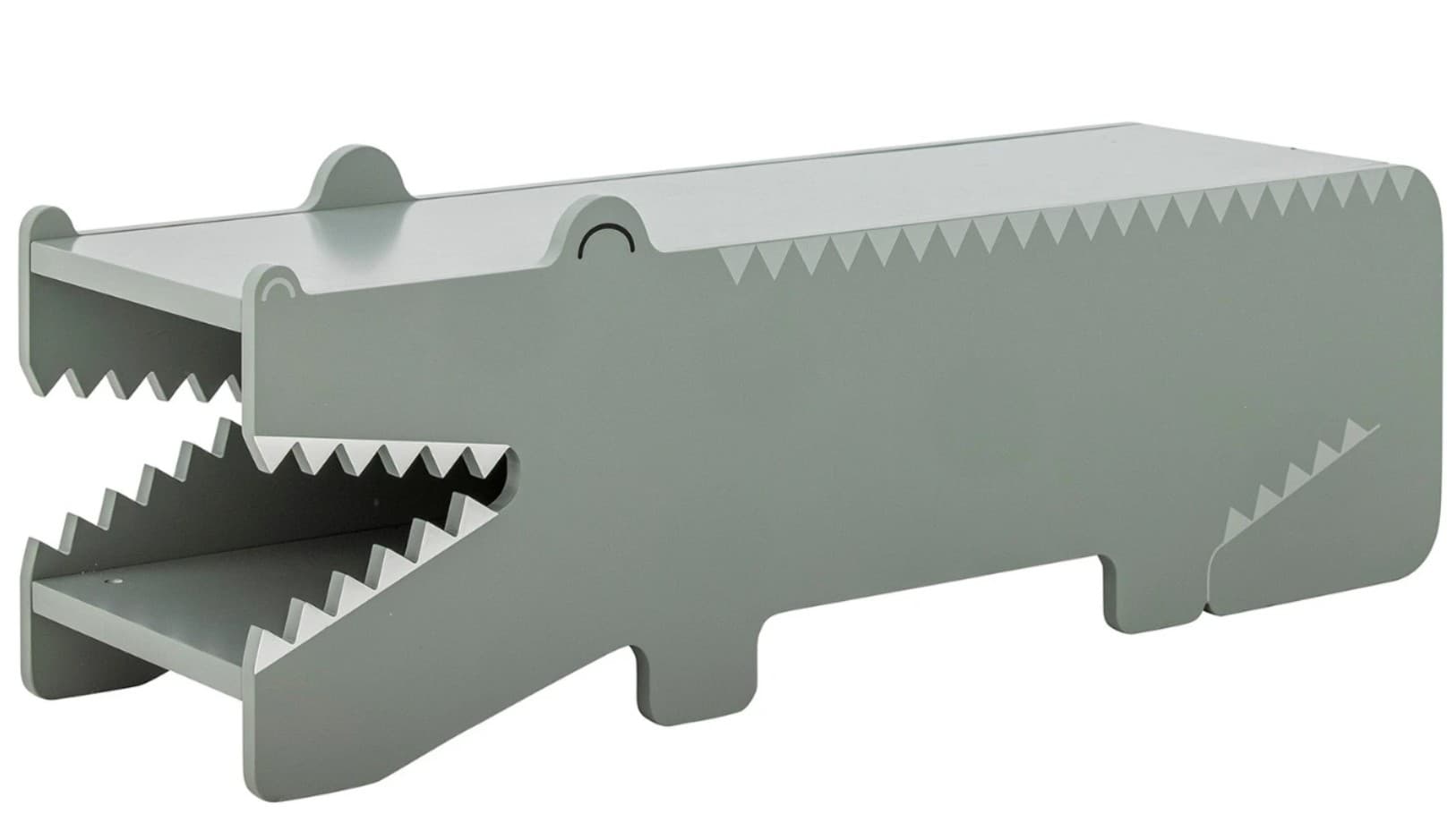A children's storage unit designed in the shape of a crocodile, rendered in a muted green-gray finish. The unit features an open 'mouth' with two internal shelves, mimicking teeth with serrated edges. Decorative details include small eyes and scales along the back, contributing to its playful, animal-inspired aesthetic. It is likely constructed from painted wood or MDF. — 3D model