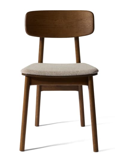 A contemporary dining chair featuring a solid oak wood frame with a clear, light-brown finish and a subtly curved wooden backrest. The seat is upholstered in a light beige, textured fabric. The chair stands on four sturdy, tapered wooden legs, with visible wood grain throughout the frame, suggesting a natural and minimalist design. — 3D model