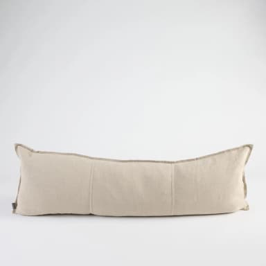 A long, rectangular bolster pillow made from a light beige woven fabric, featuring piped edges and subtle segmentation stitches across its body. The pillow is shown against a plain white background. — 3D model