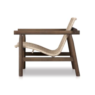 A modern armchair with a wooden frame and a woven rattan seat and back. The armchair features a robust, dark-stained wooden frame with visible grain. The seat and backrest are constructed from tightly woven natural-toned rattan, providing a contrasting texture. The armrests are extensions of the wooden frame, formed by cylindrical wooden pieces. — 3D model