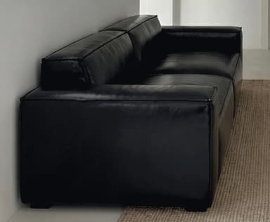 A contemporary two-seater sofa upholstered in black leather or faux leather, featuring a minimalist design with clean lines. It has squared armrests, two distinct seat cushions, and two back cushions, all presenting a smooth, unadorned surface. The sofa sits low to the ground on what appear to be short, recessed block feet, contributing to its modern aesthetic. — 3D model