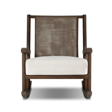 A rocking chair with a dark wood frame and woven cane back. The seat is upholstered in a white fabric. The chair has a classic rocking chair design with curved runners. — 3D model