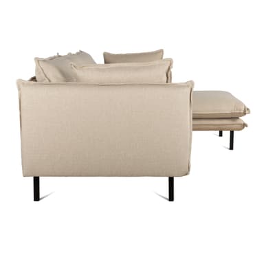 A contemporary sectional sofa, seen from the rear and side, upholstered in light beige/greige fabric with black metal legs. It features multiple loose back cushions and a low-profile design. — 3D model