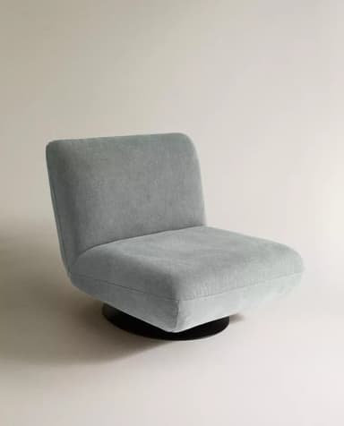 An armless upholstered lounge chair featuring a low-profile, minimalist design with a concealed swivel base. The chair is fully upholstered in a light grey-blue textured fabric, presenting a modern aesthetic. — 3D model