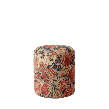 A cylindrical ottoman upholstered in a fabric with a detailed floral and botanical pattern. The pattern features large red and burgundy floral motifs interspersed with smaller dark blue and olive green elements against a light beige or cream background. The shape is a simple cylinder with a rounded top surface. — 3D model