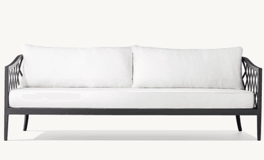 A two-seater sofa with a dark-colored metal frame and white cushions. The frame features an open, geometric lattice design on the armrests and a clean, linear structure for the base and legs. The seat and back are upholstered with plush white cushions. — 3D model