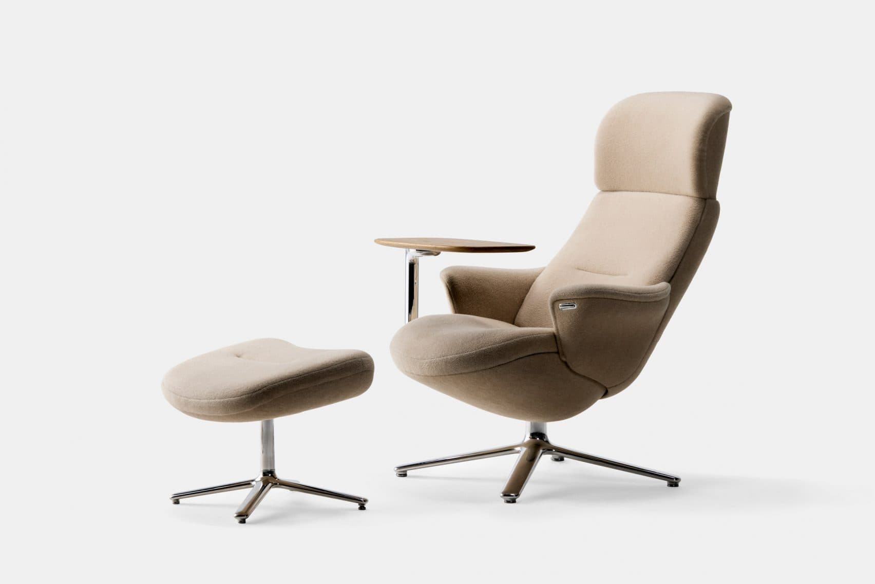 A modern armchair with a high back, upholstered in a textured beige fabric, accompanied by a matching ottoman. The armchair features integrated armrests and a small, attached wooden tray on a polished metal support. Both the chair and ottoman are mounted on a four-star base with polished metal legs, allowing for swivel functionality. — 3D model