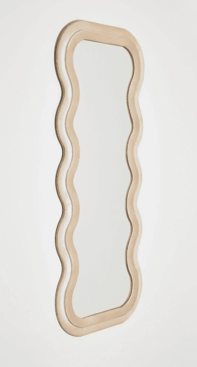 A decorative mirror with a unique, undulating frame. The frame has a soft, plush appearance and follows a continuous, wavy pattern around the reflective surface. The mirror itself is rectangular with rounded corners and a smooth, clear reflective surface. — 3D model