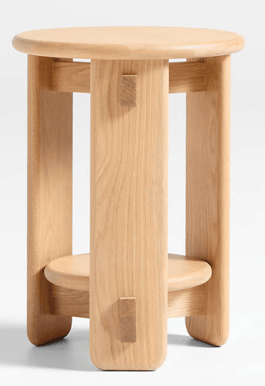 A minimalist natural ash wood stool featuring a round top, a smaller round lower shelf, and distinctive visible pegged joinery, presented against a white background. — 3D model
