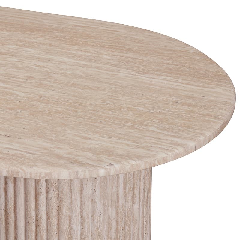 A close-up view of a coffee table with a rounded, possibly oval or kidney-shaped, top made of travertine marble. The base appears to be cylindrical and textured with vertical fluting, also made of travertine. The natural veining of the stone is prominent on the tabletop. — 3D model